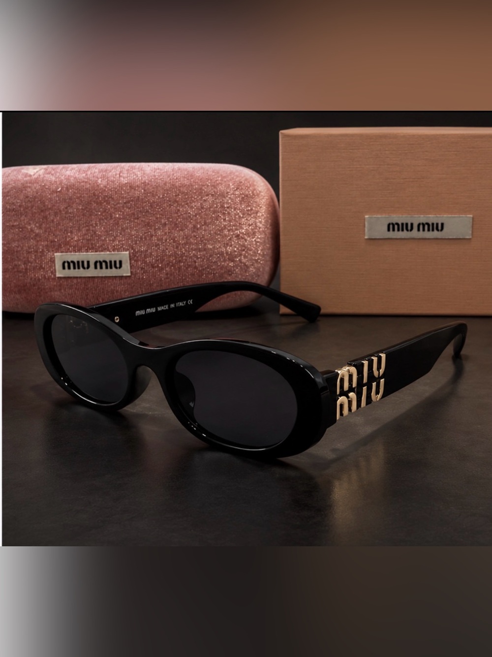 Miu Miu Black Oval Sunglasses with Gold Logo Temples